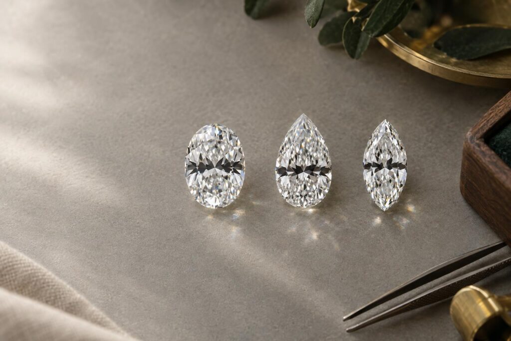 Oval, pear and marquise diamonds side by side, each showing a dark bow-tie band of different strength