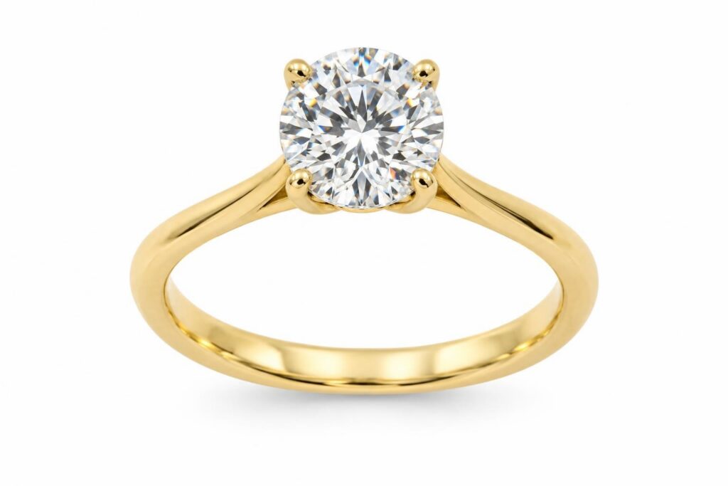 Solitaire ring with a round diamond held by four slim gold prongs