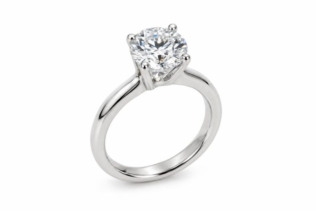 Platinum solitaire ring with a round diamond held by four slender claws