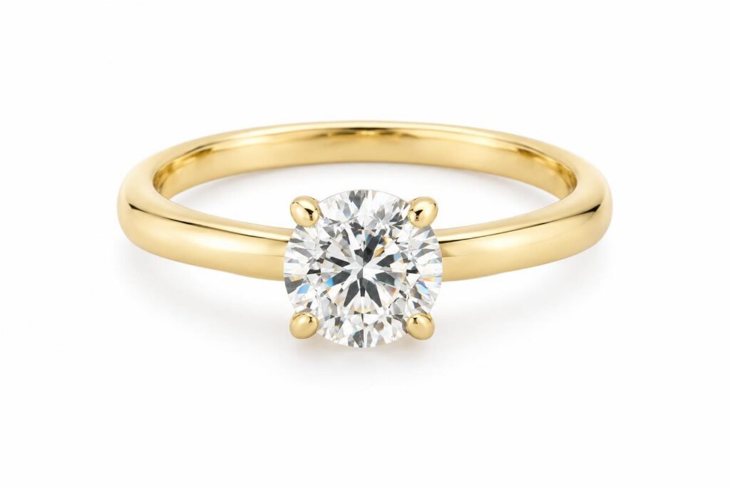 Yellow gold solitaire ring with one round brilliant diamond on a plain band