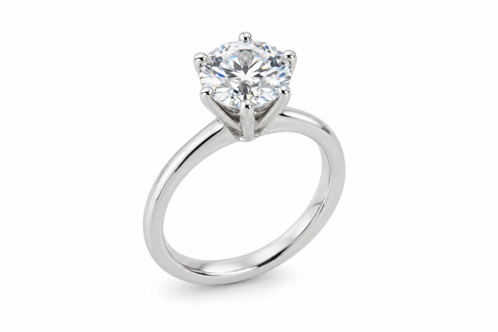 Solitaire ring with a round diamond held by six slim prongs on a plain band
